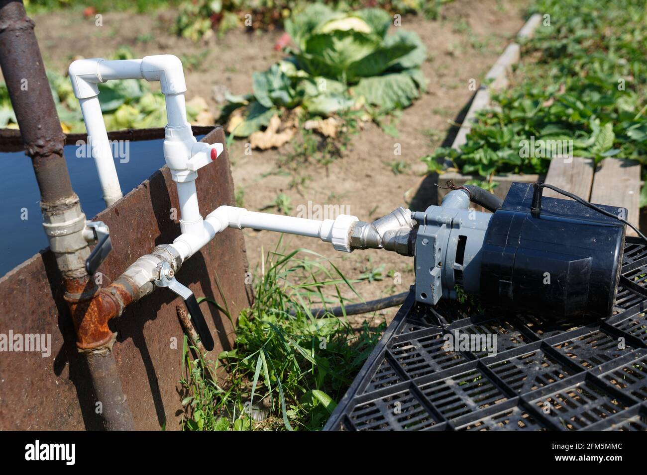 Connection of plastic pipes to the pump and water storage tank. Pumping water using a homemade