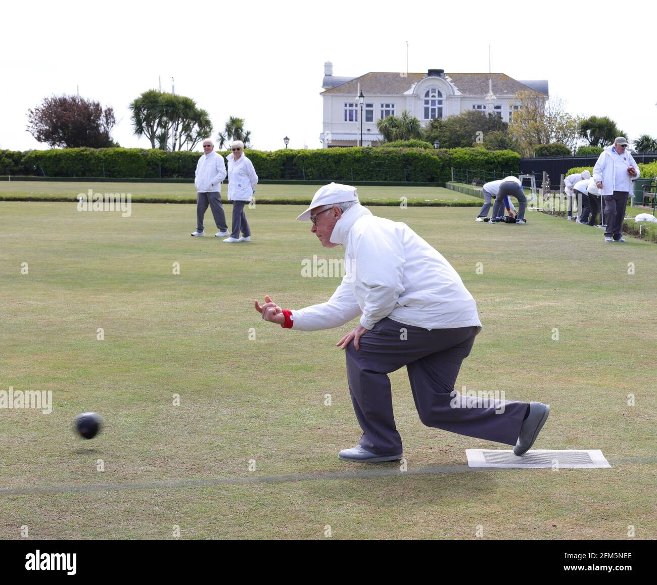 Pensioner seen being exercising bowling outdoors. Stock Photo