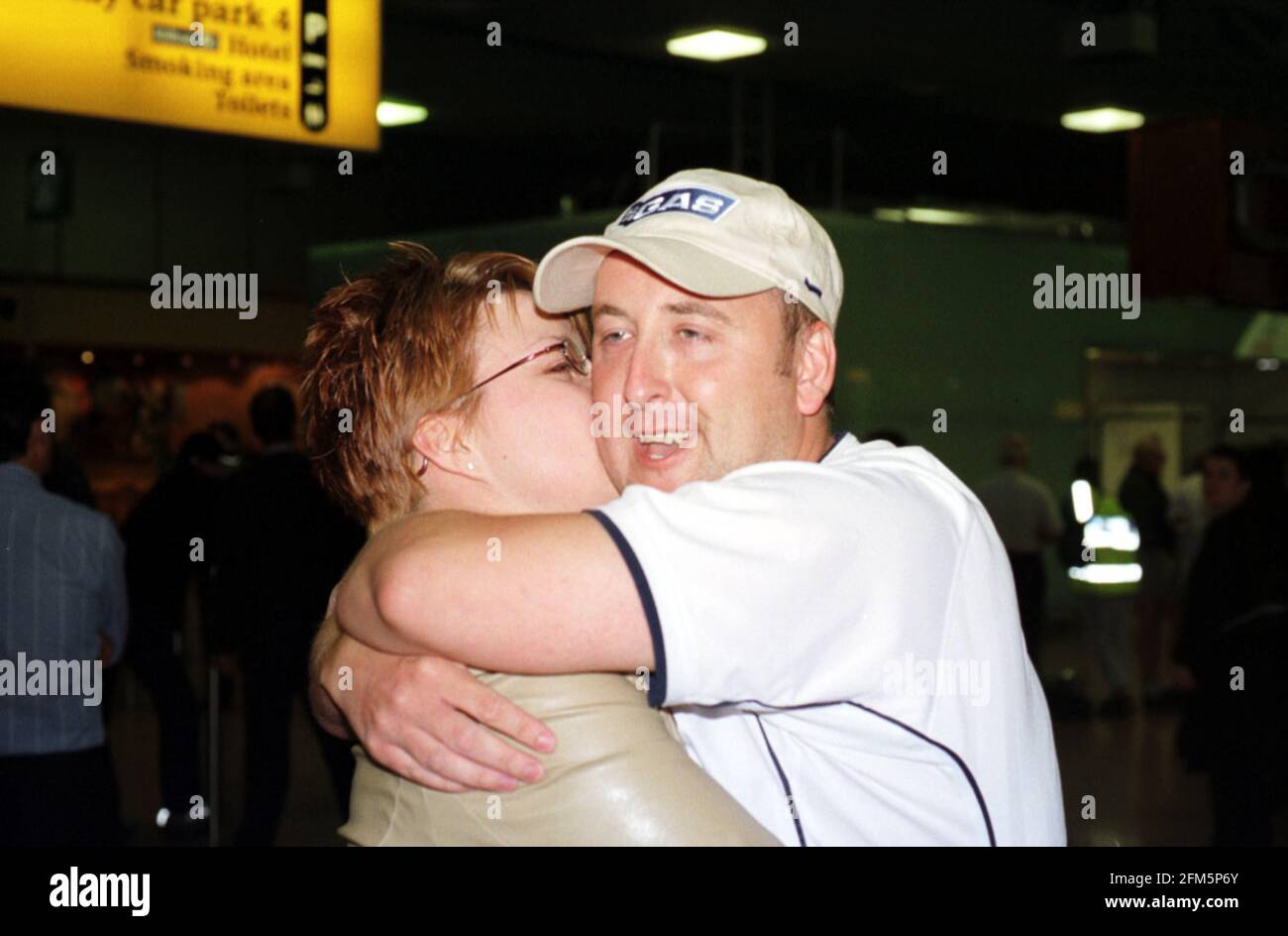 Mark Turner is reunited with his girlfriend Emma Lynch two of the Britons caught up in the Tamil Tiger attack on Columbo Airport seen here returning to Heathrow Airport Stock Photo