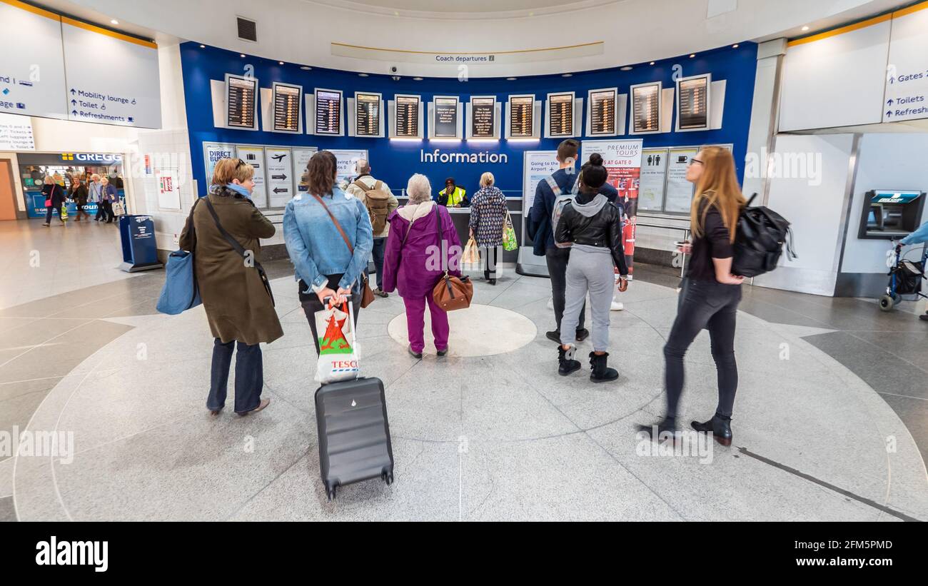 London Victorian coach station information desk. Travellers arriving