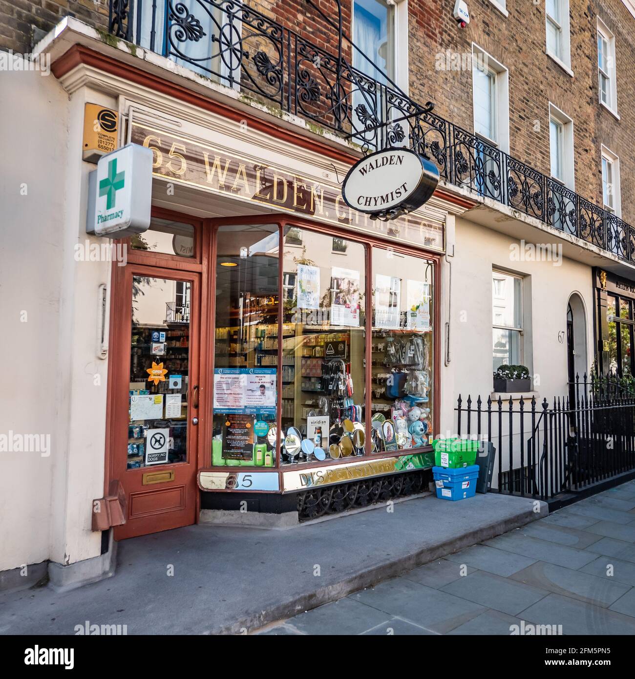 Traditional English Chemist Shop. The display window and façade to a small business London shop on the streets of Kensington and Chelsea. Stock Photo
