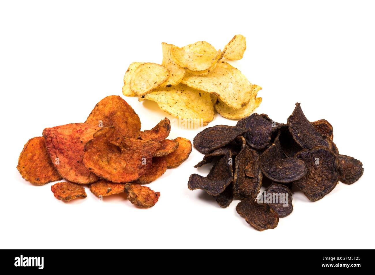 Three varieties of kettle-cooked potato chips, made of yellow, red and blue potatoes, isolated on white background Stock Photo