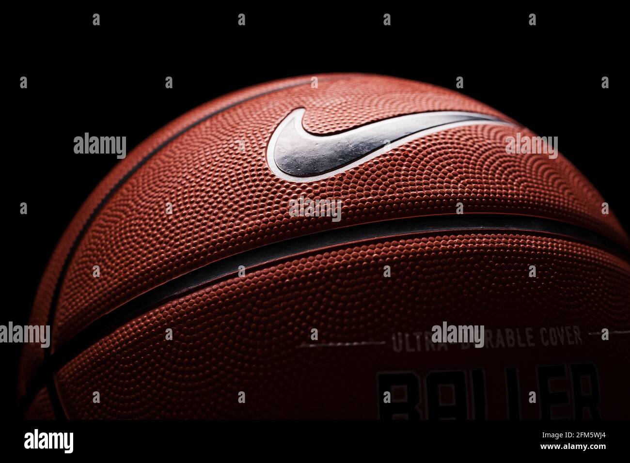 Nike brand, basketball ball Nike Baller. Orange rubber outdoor ball, ultra-durable  cover, close-up on a black background Stock Photo - Alamy