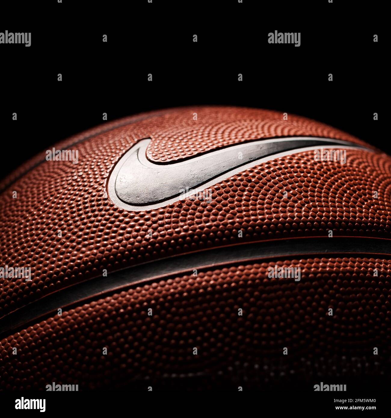 Nike brand, basketball ball Nike Baller. Orange rubber outdoor ball,  ultra-durable cover, close-up on a black background Stock Photo - Alamy