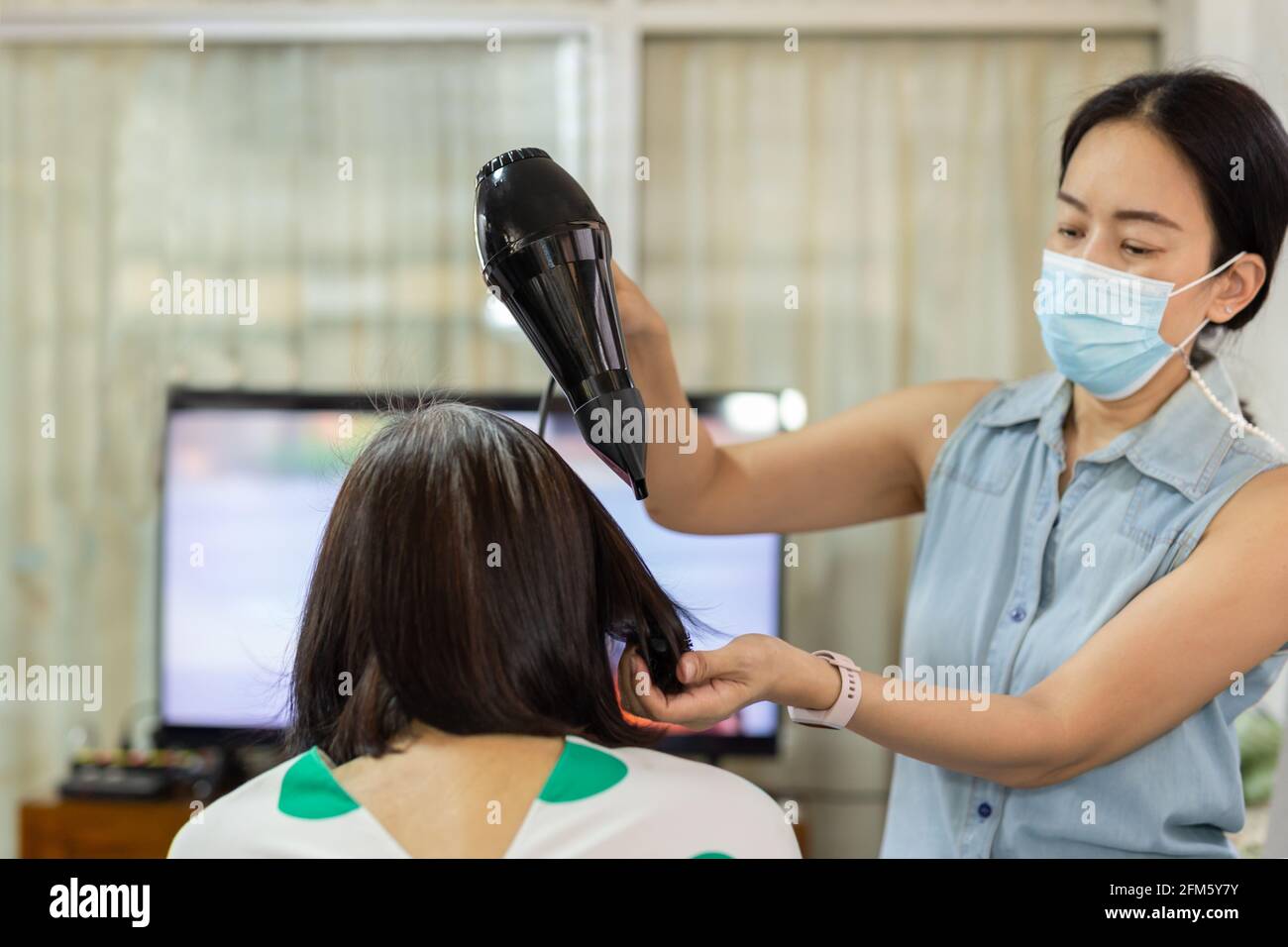 Asian woman drying hair hi-res stock photography and images - Alamy