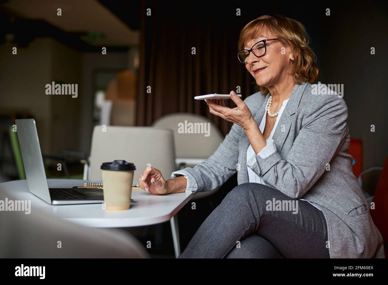 Mature female listening to her interlocutor online Stock Photo