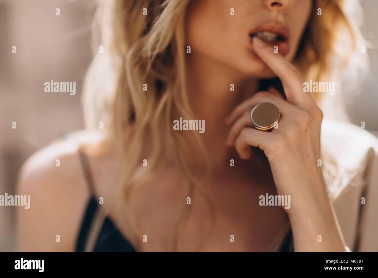 Defocused art portrait of a beautiful blonde woman through the glass in beige tinting. Out of focus Stock Photo