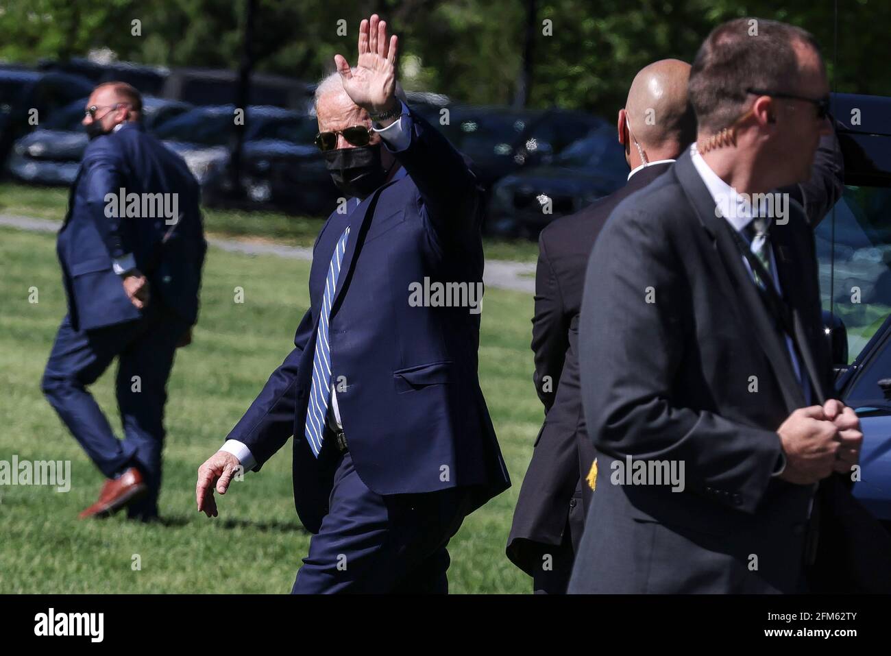 President Joe Biden waves as he walks on the Ellipse near the White ...