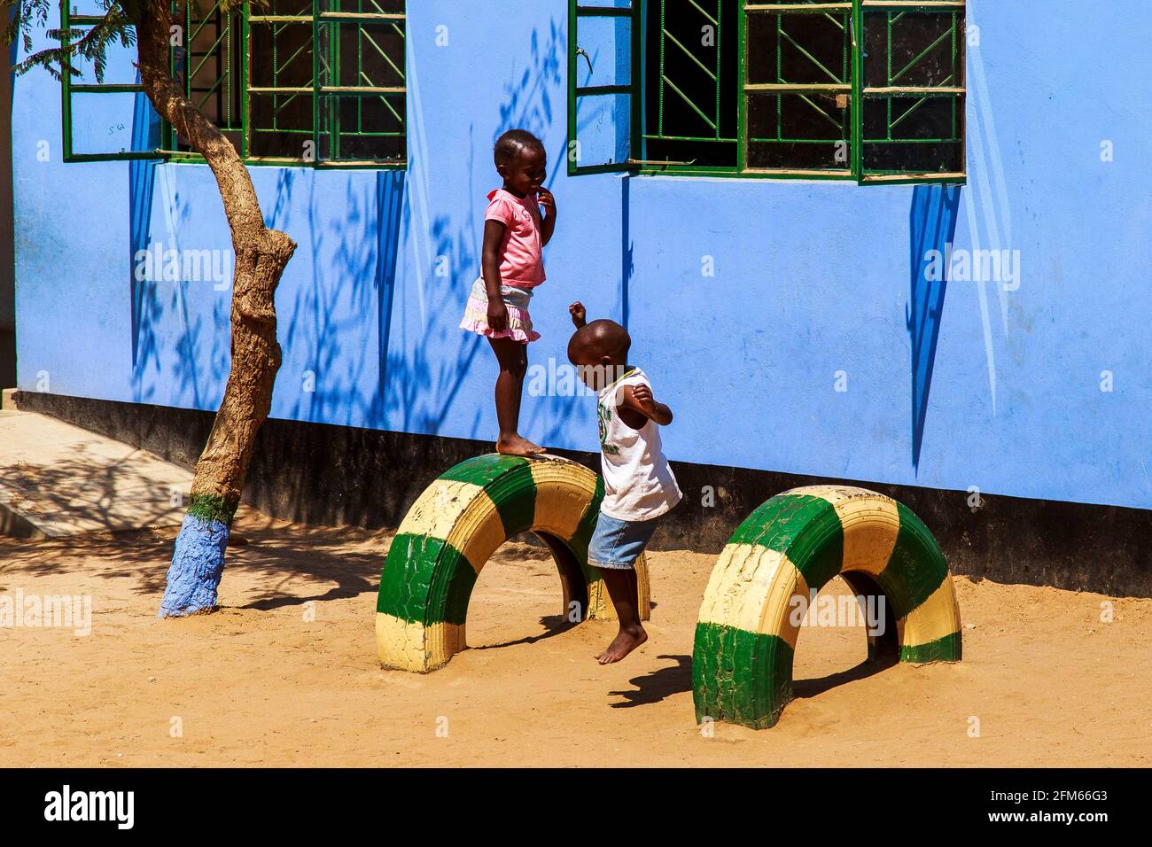 Jumping down! two children at school in Livingstone, Zambia Stock Photo