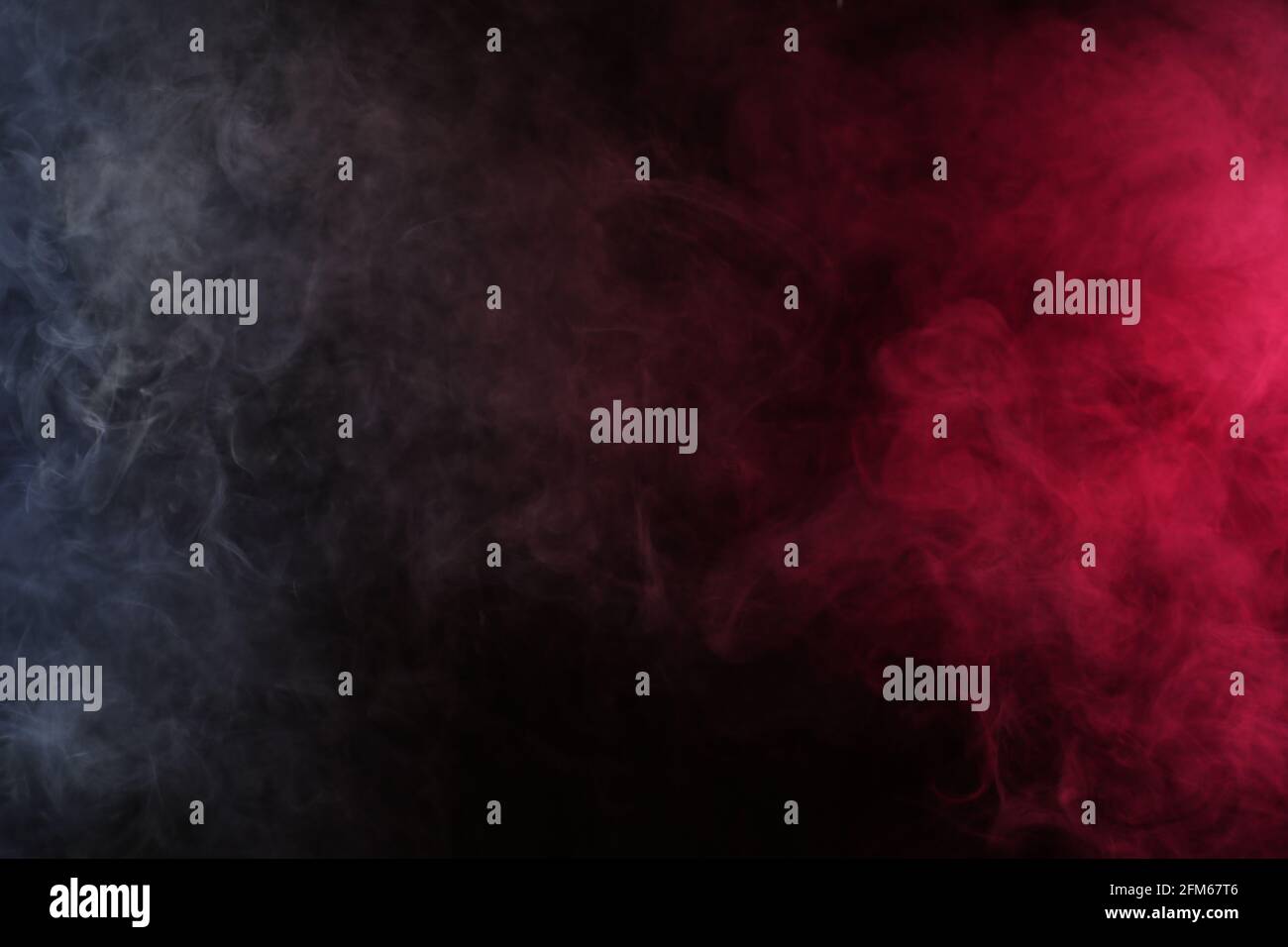 Artificial smoke in white-red light on a black background Stock Photo