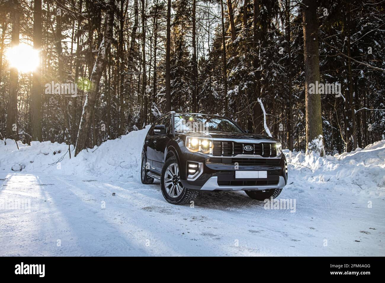 Moscow, Russia - February 15, 2021: Kia Mohave 2021 black SUV parked in the forest in winter. General shot of the car from the front. Controlled skidding in snowdrifts. Stock Photo