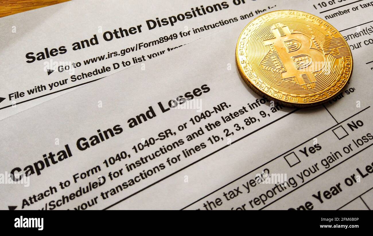 Qawra, Malta 27.04.2021 - Cryptocurrency and capital gain. Bitcoin over  8949 form and schedule D of form 1040. USA taxation Stock Photo - Alamy