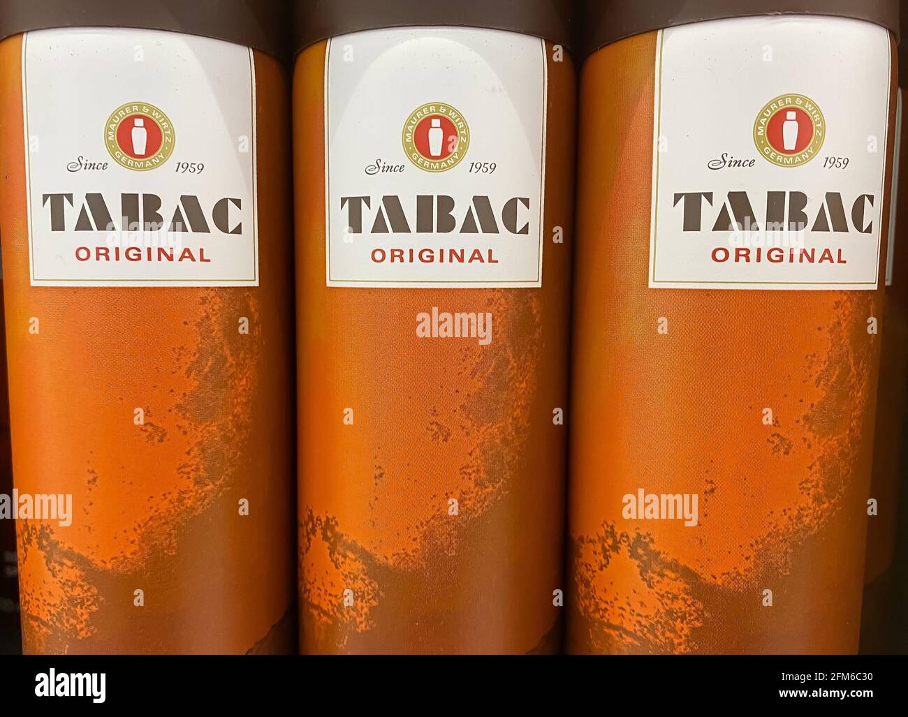 Viersen, Germany - May 6. 2021: Closeup of bottles with logo lettering of tabac men perfume in shelf of german supermarket Stock Photo