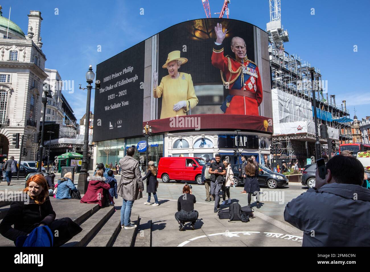 People stop to look at the famous advertising screen at Piccadilly Circus as it displayed a tribute for Prince Philip, on the day of his funeral, UK Stock Photo