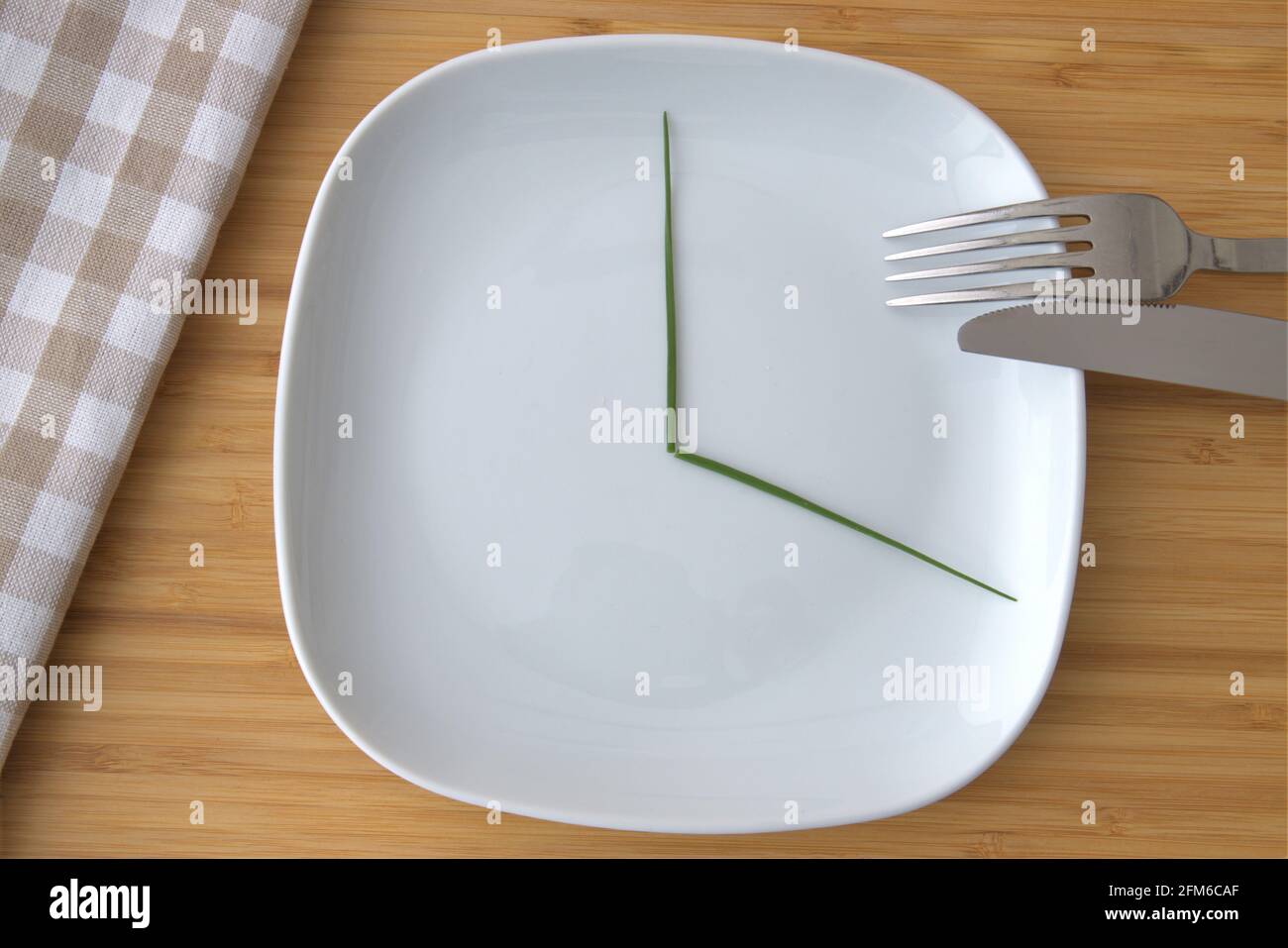 top view of a white plate with marked one third for intermittent fasting Stock Photo