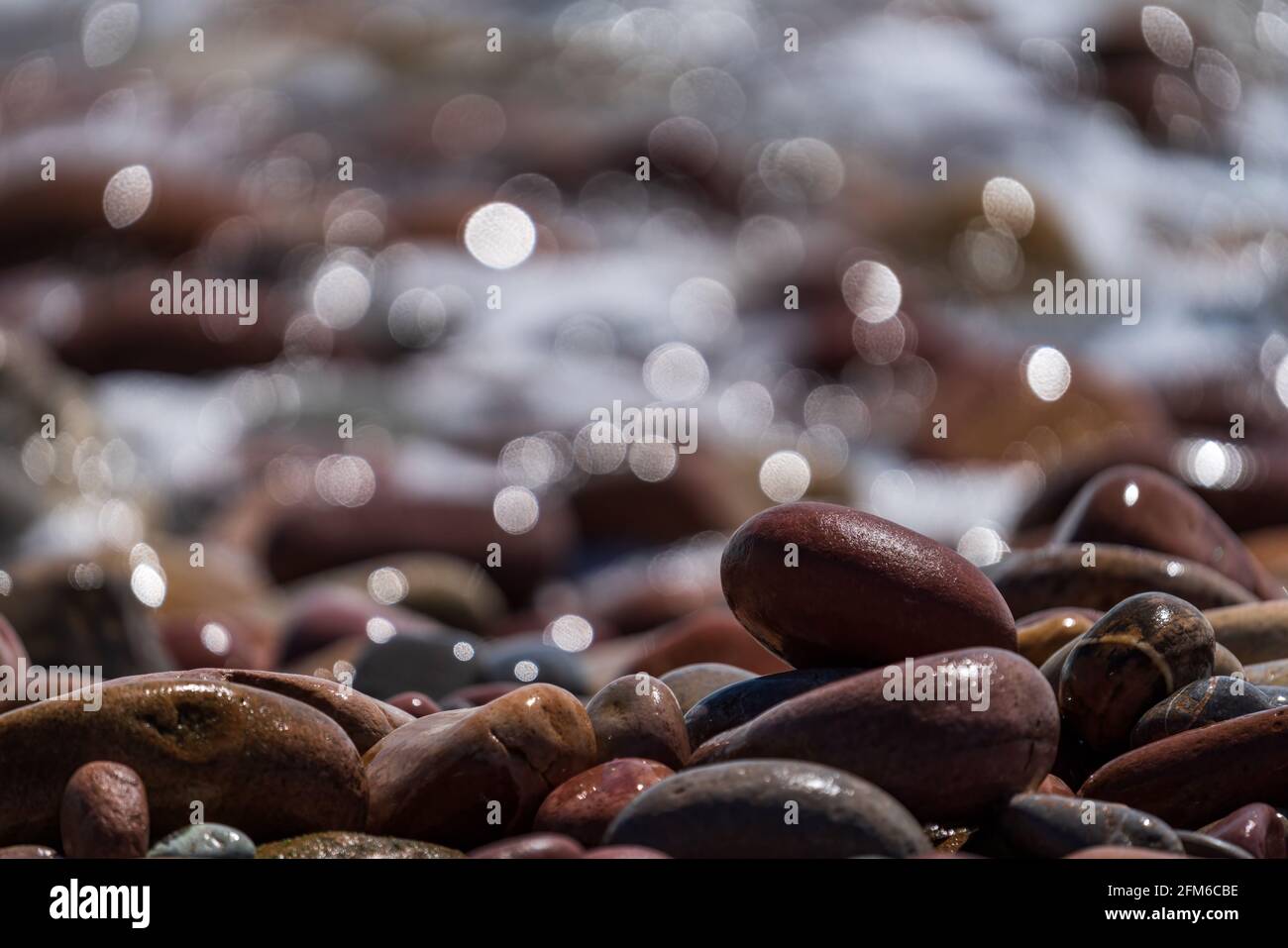 Stones near the ocean with blurred background Stock Photo