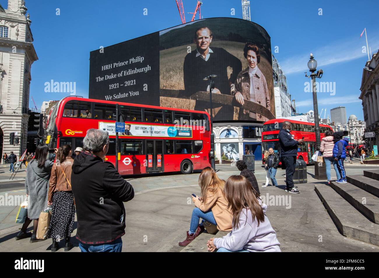 People stop to look at the famous advertising screen at Piccadilly Circus as it displayed a tribute for Prince Philip, on the day of his funeral, UK Stock Photo