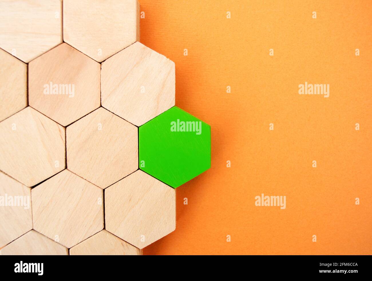 One green hexagon stands out from the rest. Leadership and victory concept. Dissimilarity and dissent. Uniqueness initiative. Superfluous, unsuitable. Stock Photo