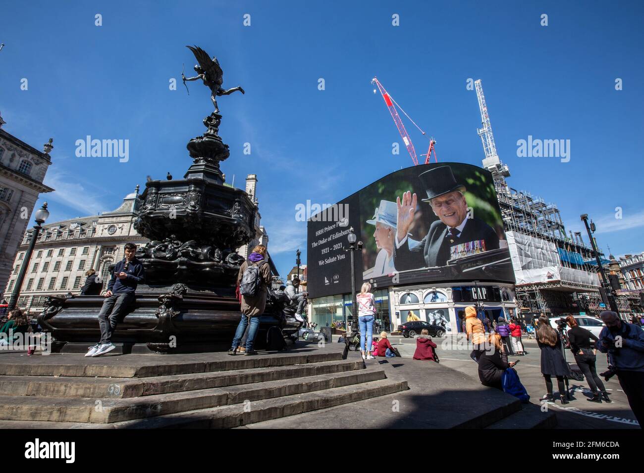 People stop to look at the famous advertising screen at Piccadilly Circus as it displayed a tribute for Prince Philip, on the day of his funeral, UK Stock Photo