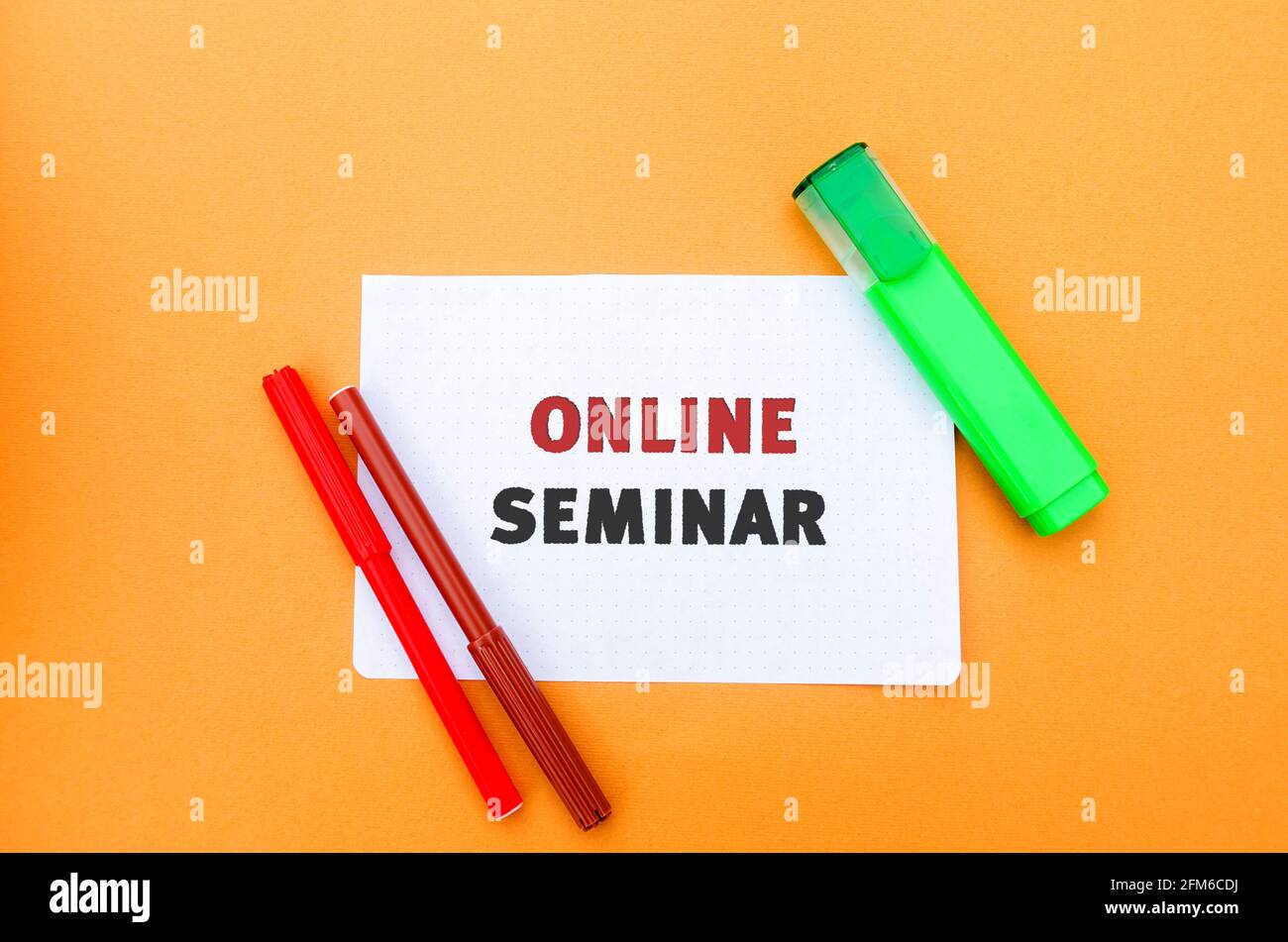 A note with the inscription Online seminar. A type of web conferencing, holding online meetings or presentations over the Internet. Webcasts, and web Stock Photo
