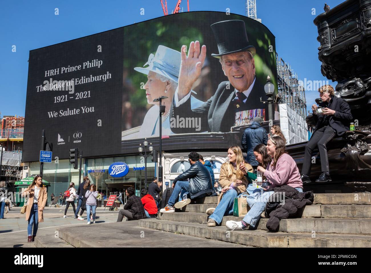 People stop to look at the famous advertising screen at Piccadilly Circus as it displayed a tribute for Prince Philip, on the day of his funeral, UK Stock Photo