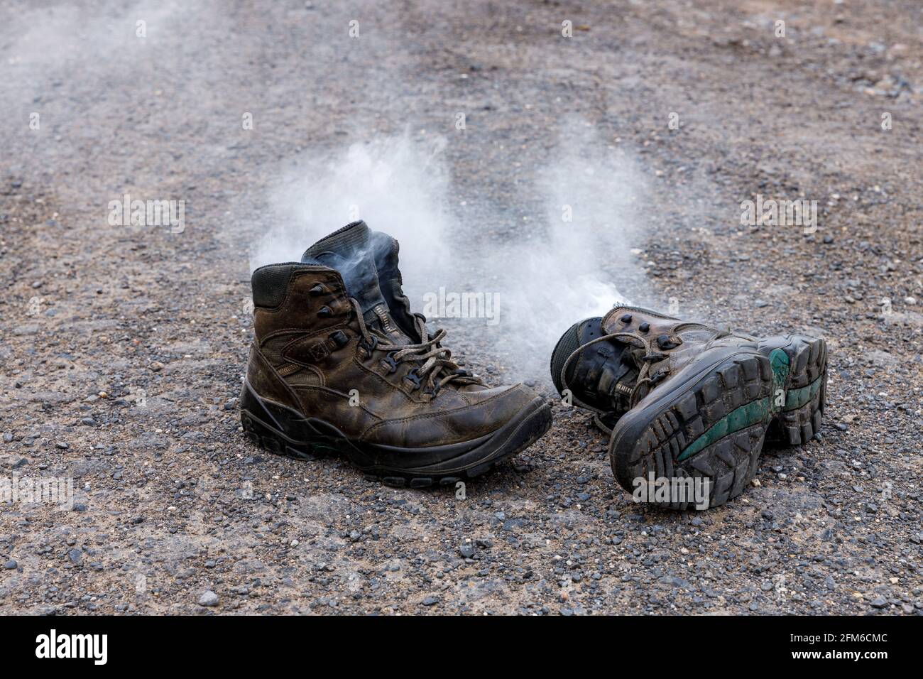 hiking boots are smoking from sweaty feet Stock Photo Alamy