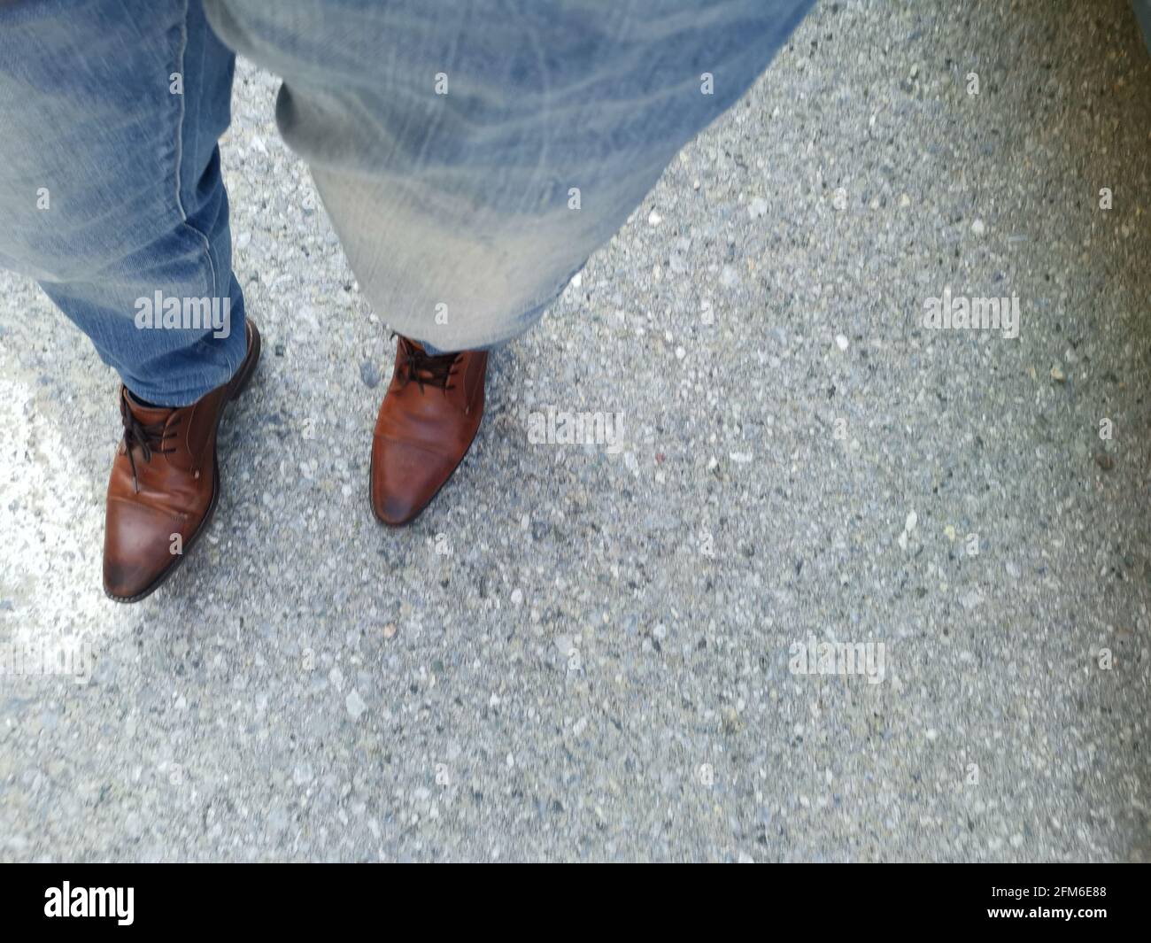two feet with jeans and shoes Stock 