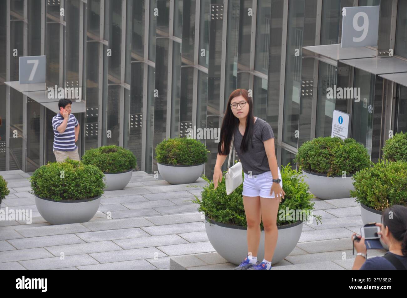 Female korean student posing in front of Ewha Campus Complex valley on a humid midsummer day in Seoul, South Korea. Stock Photo