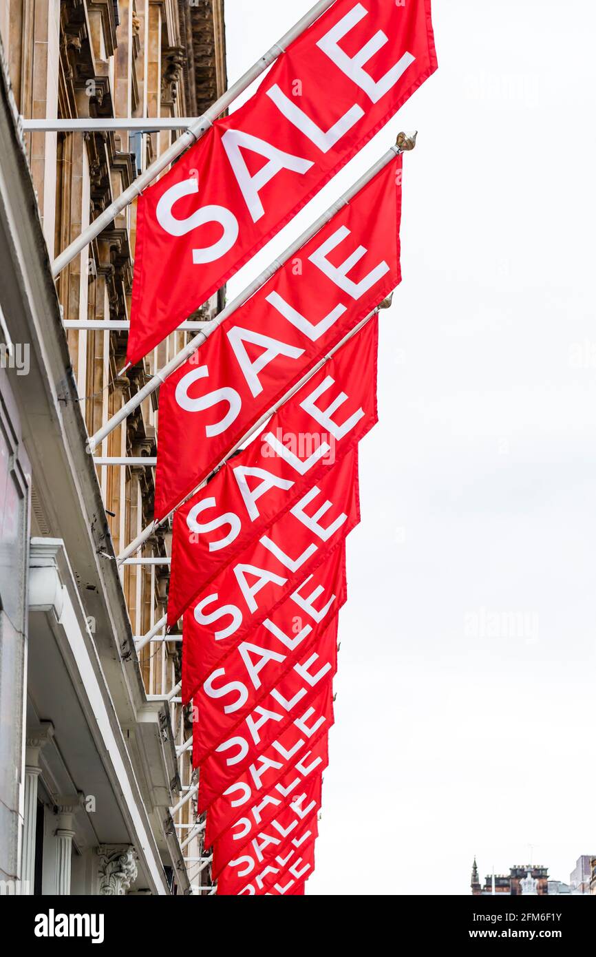 Sale signs hanging above a shop, UK Stock Photo