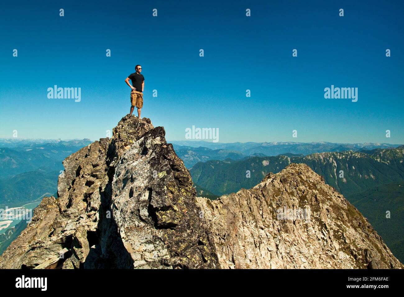 Hiker standing on mountain summit, Chilliwack, B.C. Canada. Stock Photo