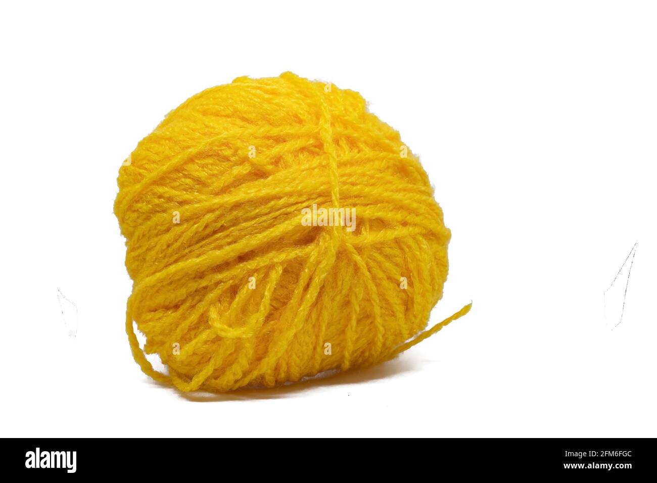 Yellow woolen ball on white background. Use to make woolens for winters. Stock Photo