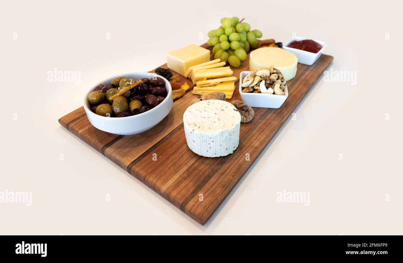 Delicious Cheese Assortment on a wooden board Stock Photo