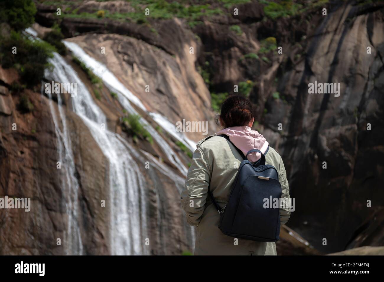 Woman watching the stunning waterfall of Ezaro. Galicia, Spain Stock Photo