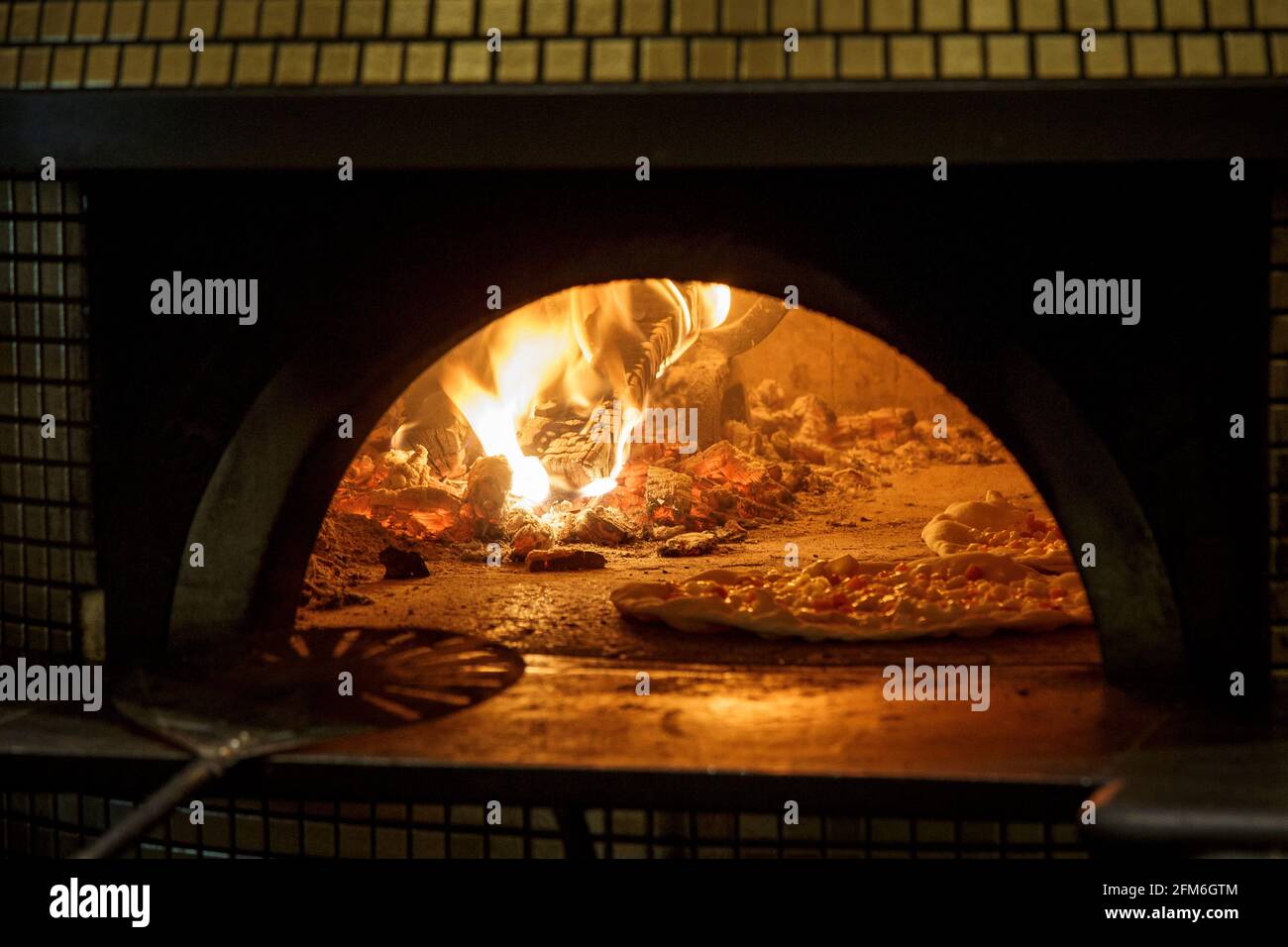 cooking pizza margherita into a hot oven Stock Photo Alamy