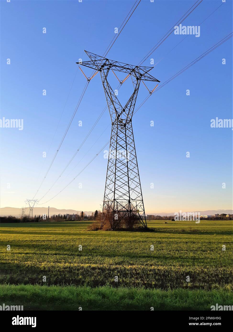 High voltage pylon in the countryside at sunset Stock Photo
