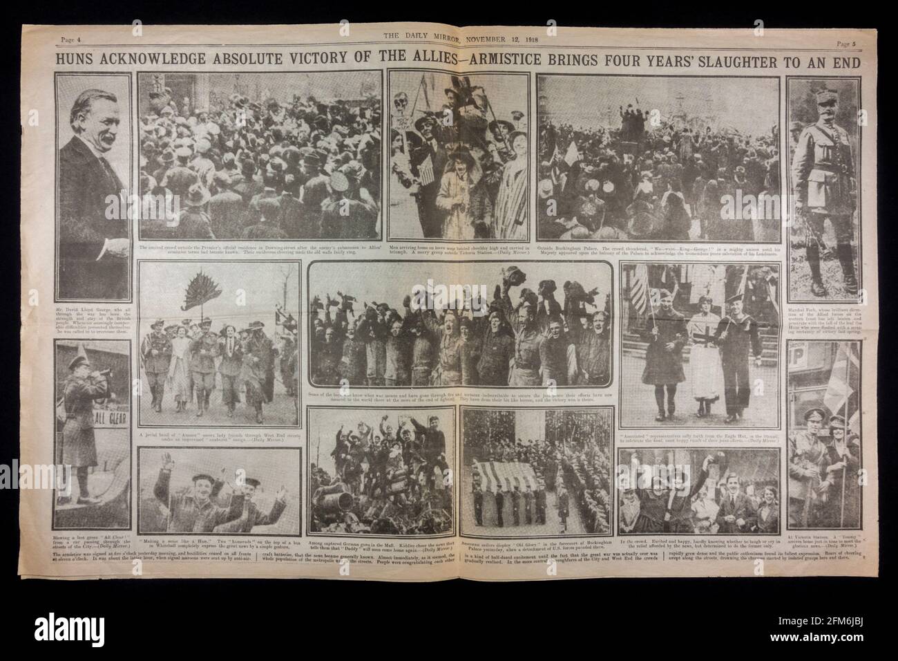 Double page spread of photographs of people celebrating the end of World War One inside the Daily Mirror newspaper (replica) on 12th November 1918. Stock Photo