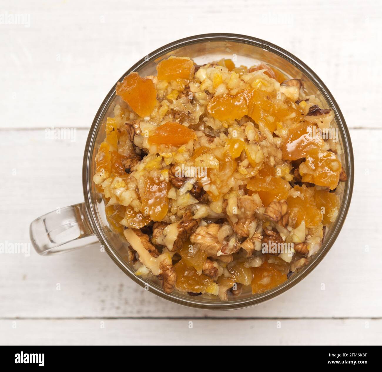 Healthy mixture of honey, dried apricots, walnut and lemon Stock Photo