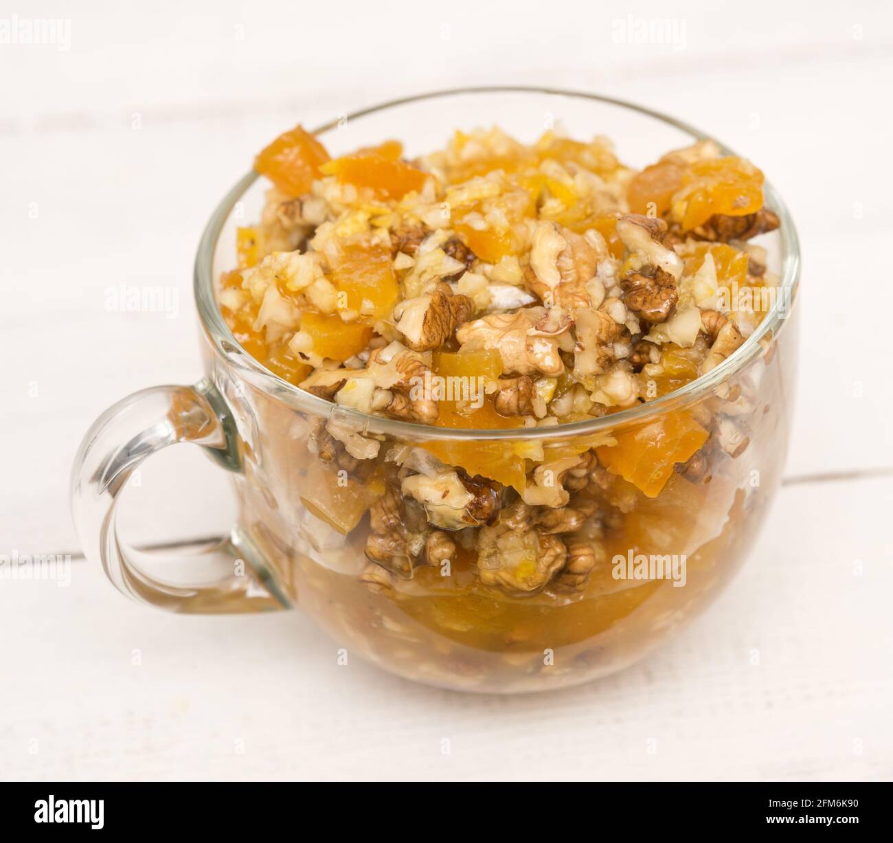 Healthy mixture of honey, dried apricots, walnut and lemon Stock Photo