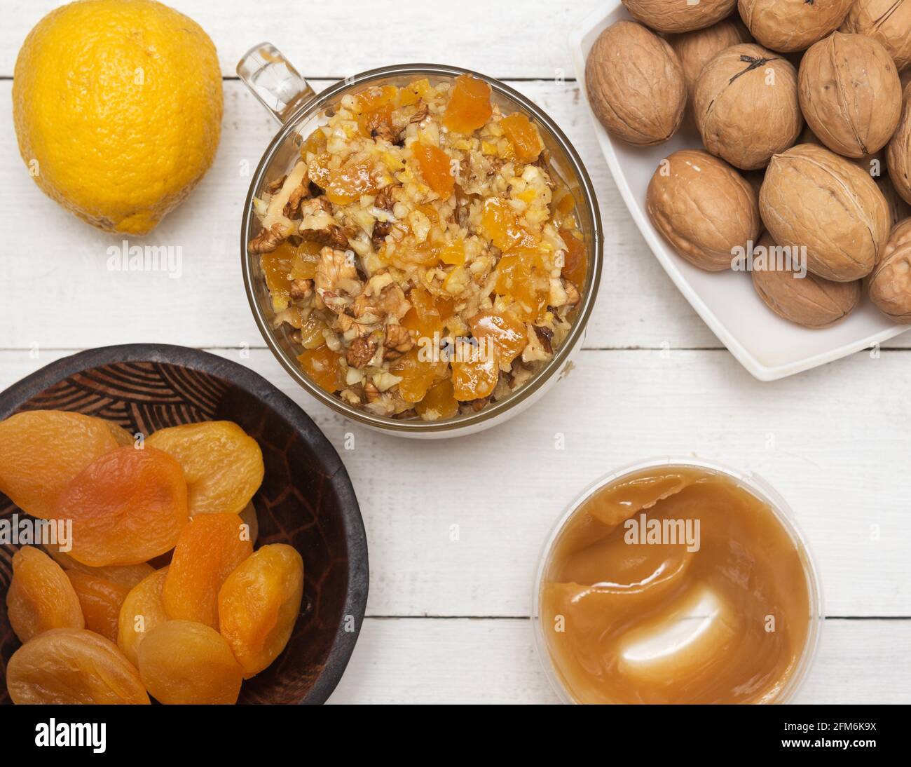 Healthy mixture of honey, dried apricots, walnut and lemon Stock Photo