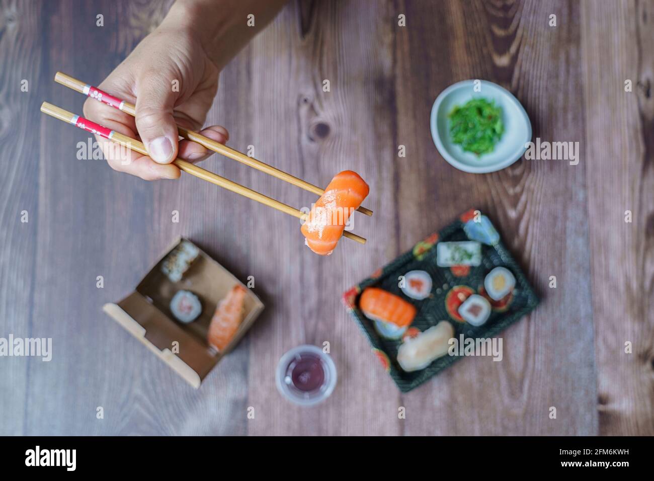 Selective focus on the hand. Top view of the arm of a man eating Asian ...