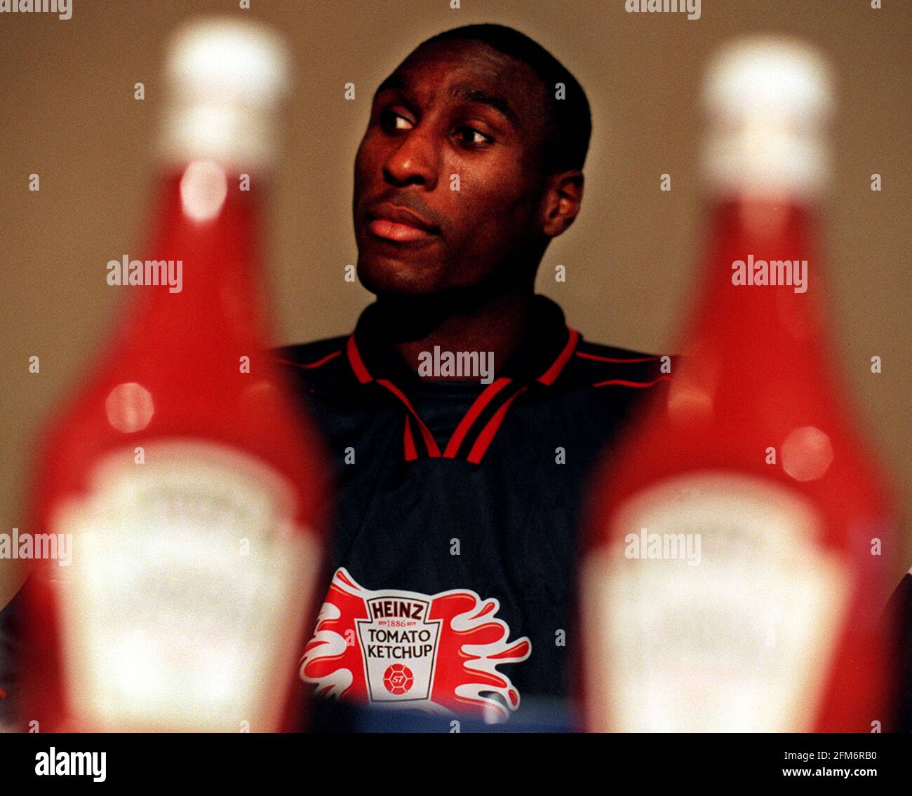 Sol Campbell Tottenham Hotspur Defender January 1999 eats his way through the first edible football draw for the heinz ketchup cup, the largest schoolboy football tournament in the uk at the sports cafe in London Stock Photo
