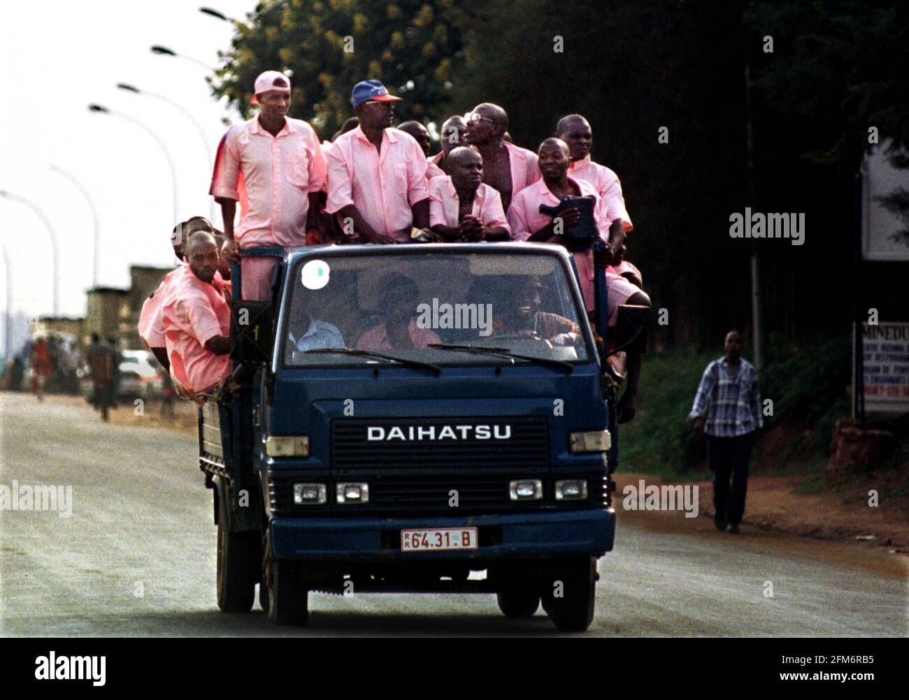 Prisoners being transported to jail at Kigali February 1999 in Rwanda after  working outside the prison for the day wearing the distinctive pink prison  uniform. Most of the prisoners will have taken