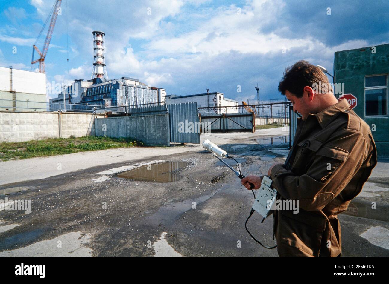 An employee of the exclusion zone measures the radioactive radiation in