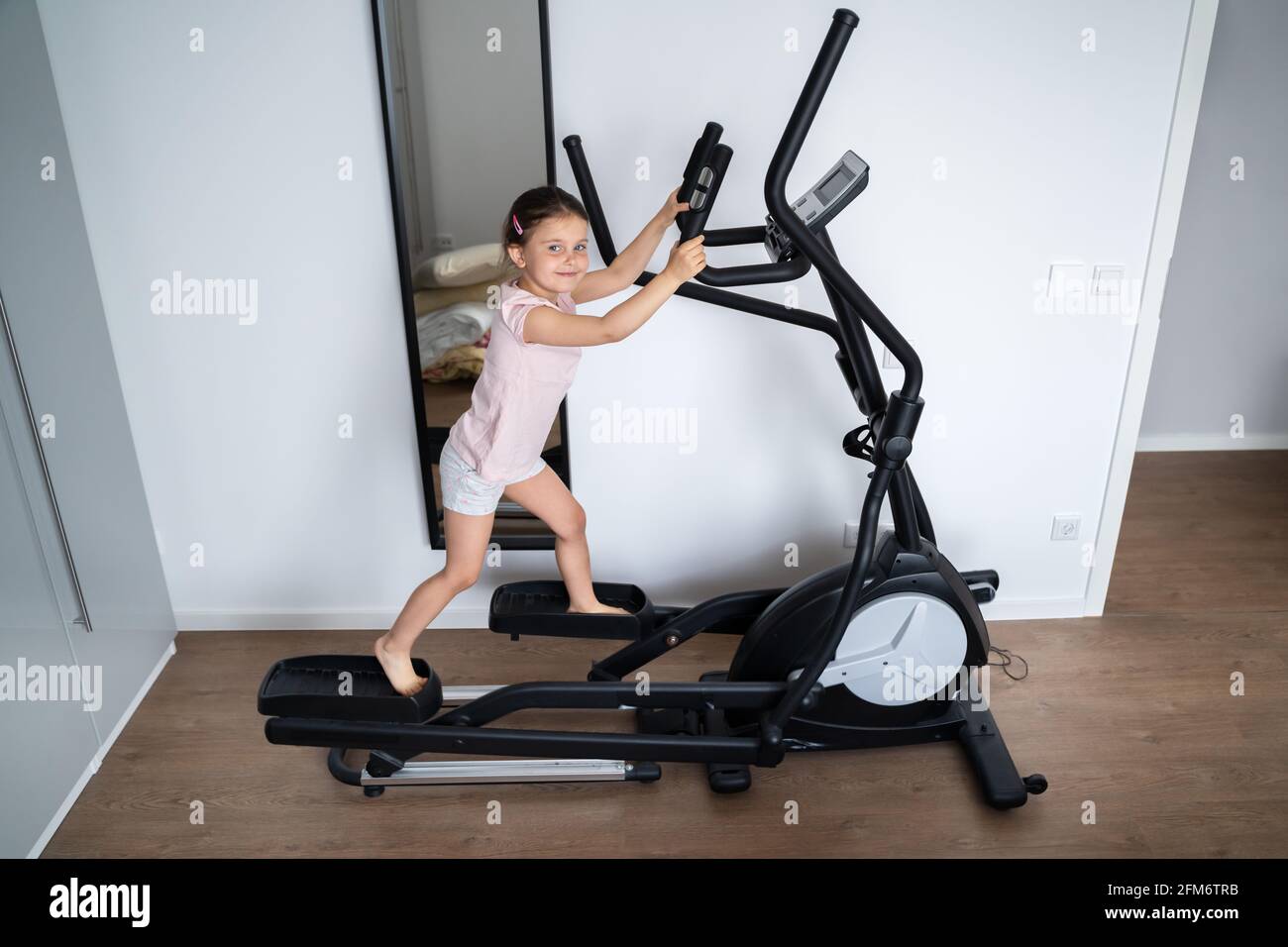 Kid Child Training On Elliptical Cross Trainer Stock Photo