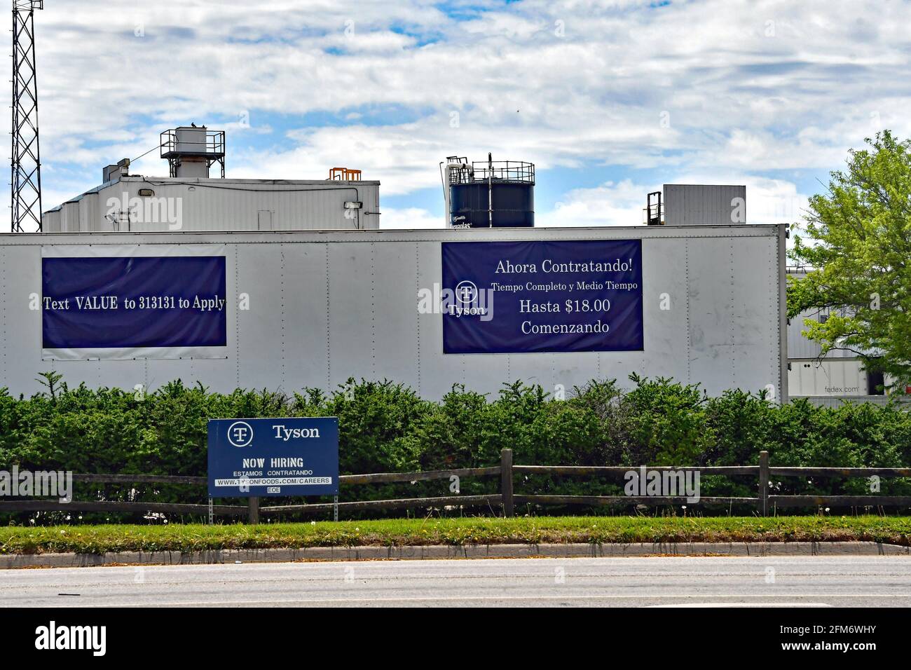 Now hiring signs in both English and Spanish are posted around the