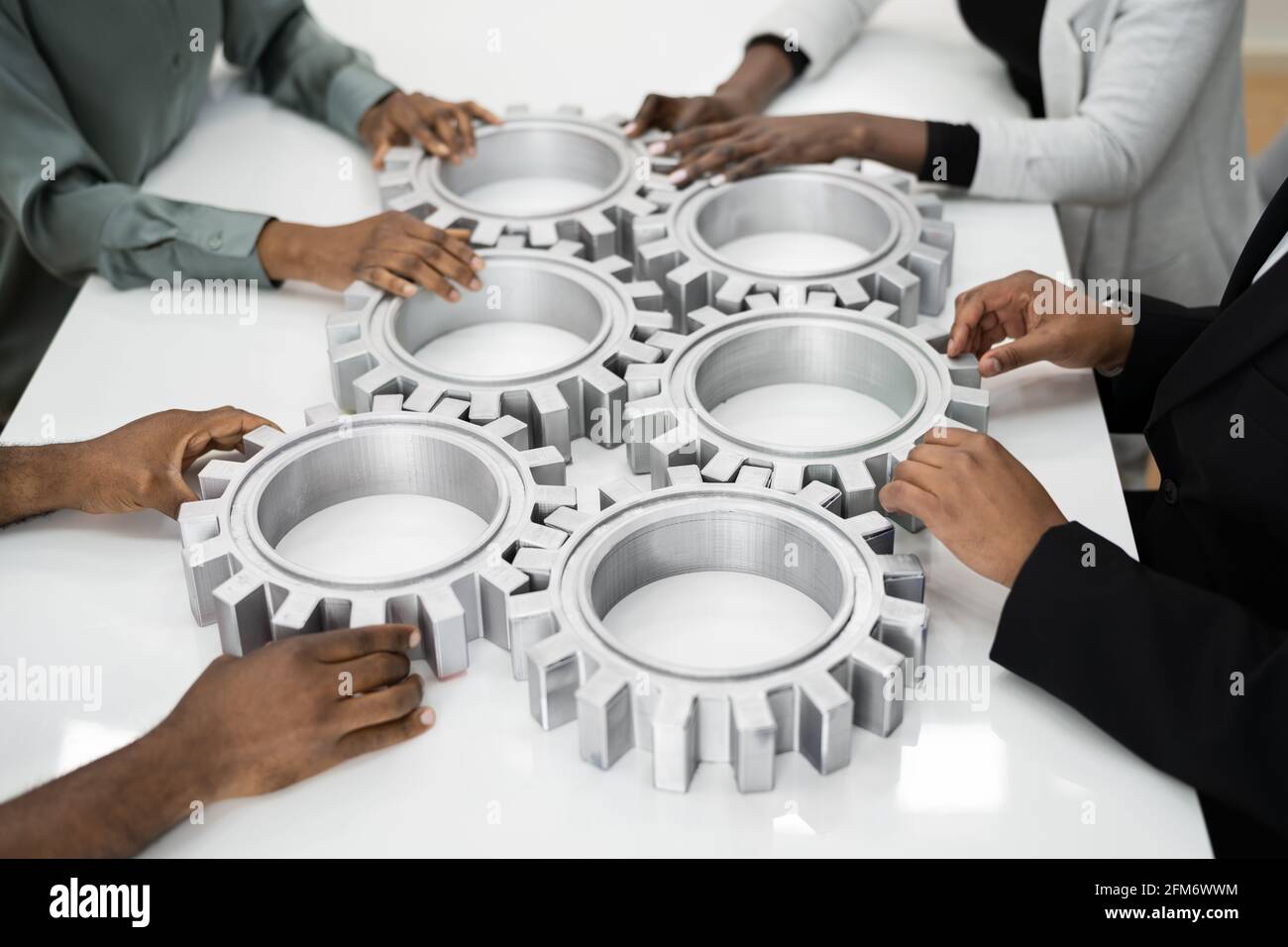 Business People Team Hands Connecting Gears. Implementation And Collaboration Stock Photo