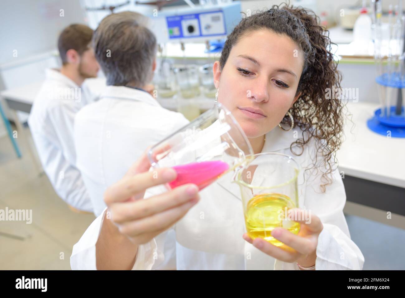 young intern chemist mixing the chemicals Stock Photo Alamy