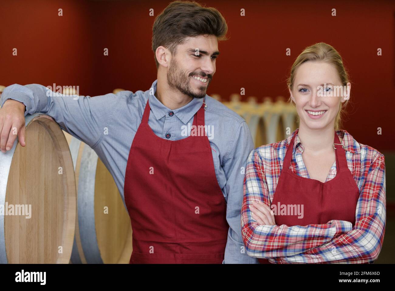 professional female and male taster of winery posing in cellar Stock ...