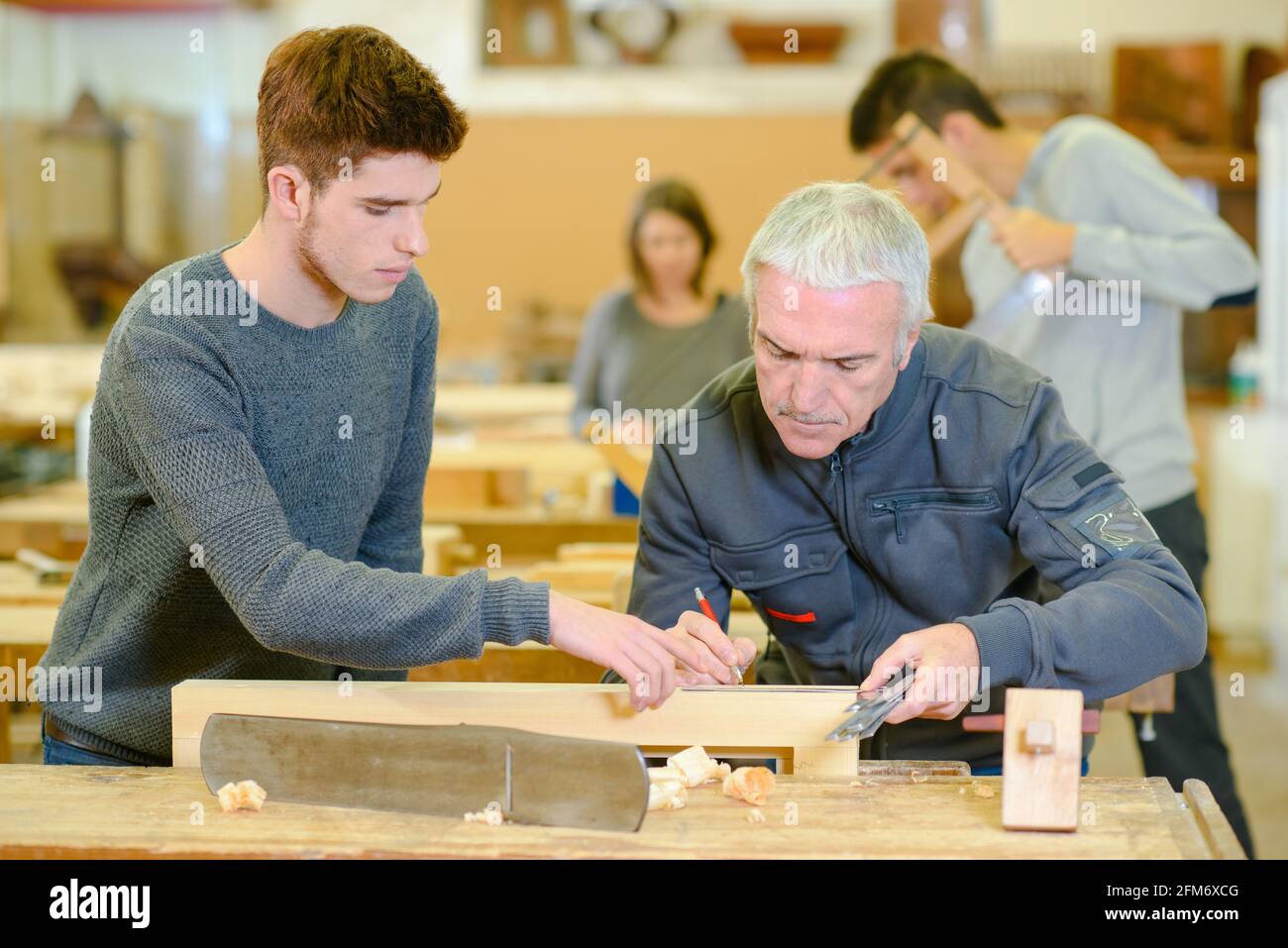 teacher and students in carpentry class Stock Photo Alamy