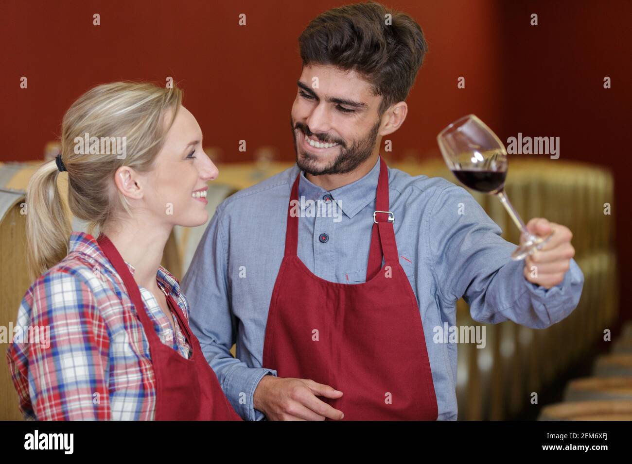 artisan wine production workers holding a glass of red wine Stock Photo